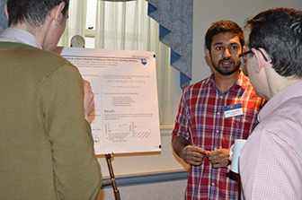 Selva Jeganathan shares poster research with faculty.